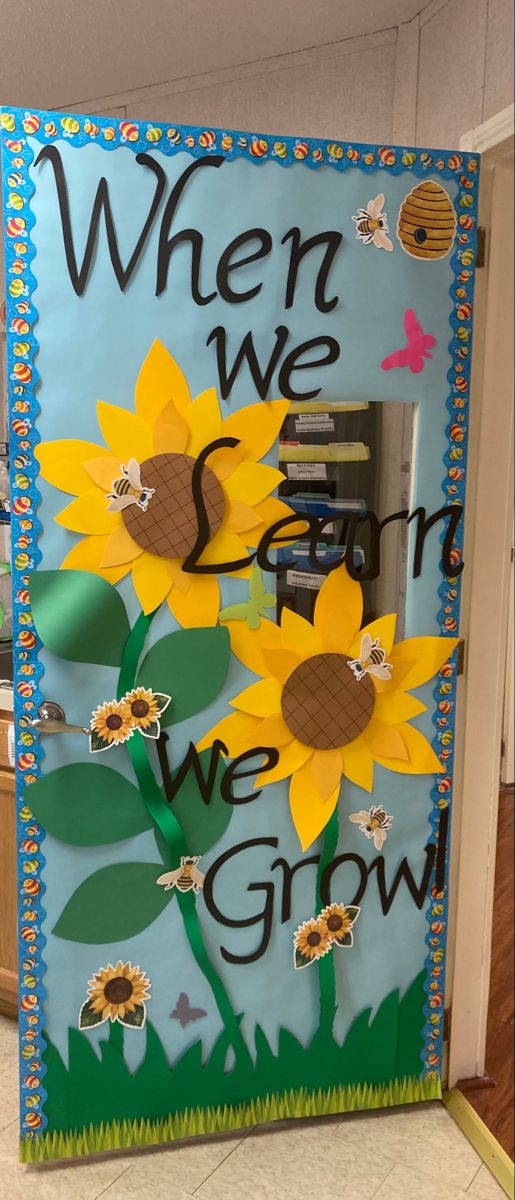 a classroom door decorated with sunflowers and the words when we grow