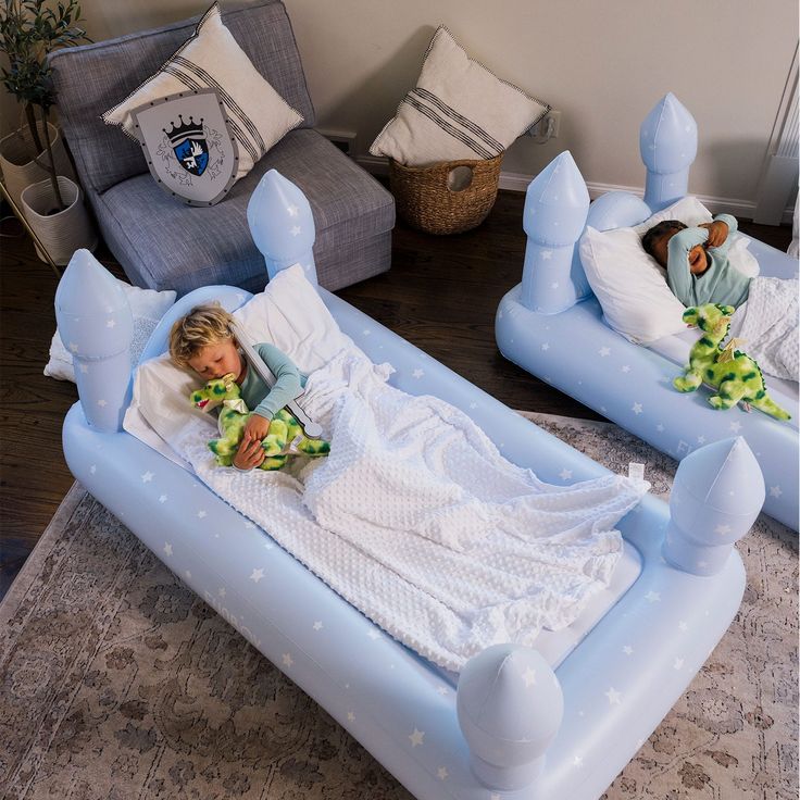 two children laying on inflatable beds with pillows