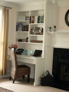 an image of a living room with fireplace and bookshelves on the shelves in it