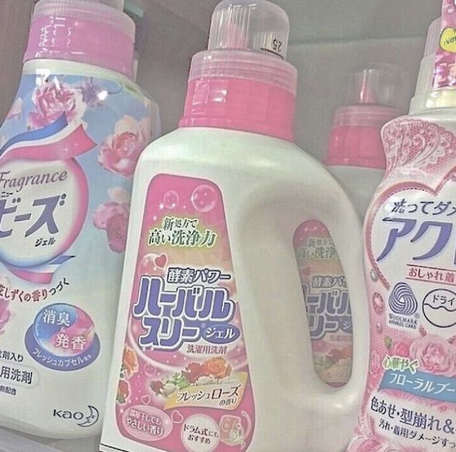 several bottles of detergent sitting on a shelf in a store, with japanese writing