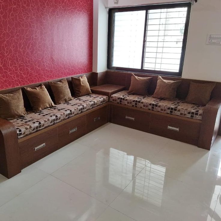 a living room filled with lots of furniture next to a large window on the wall