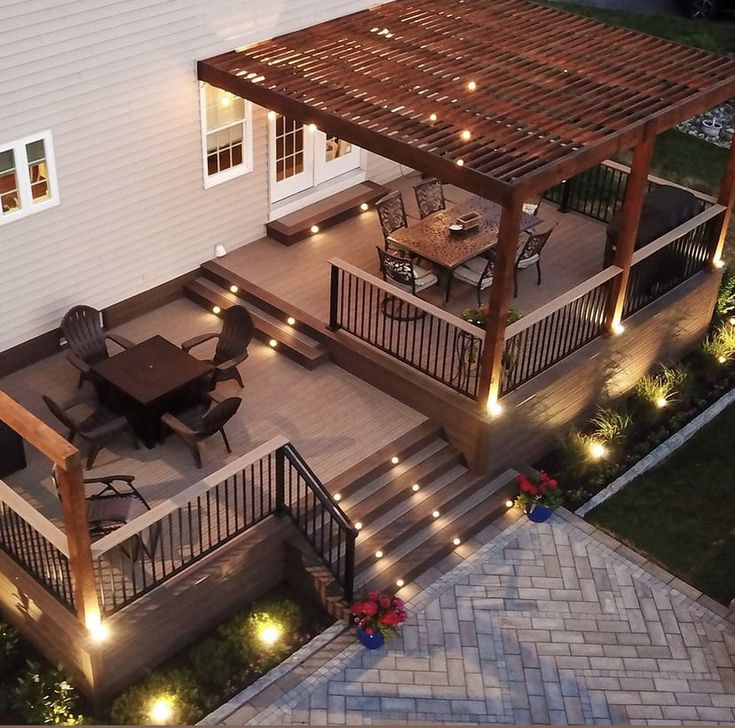 an outdoor deck with lights and patio furniture