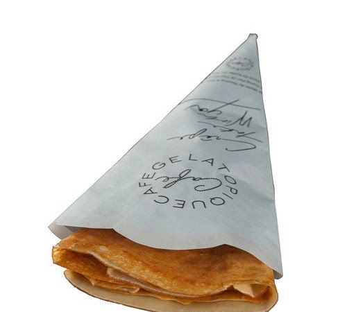 a piece of food that is sitting on top of a paper bag with writing on it