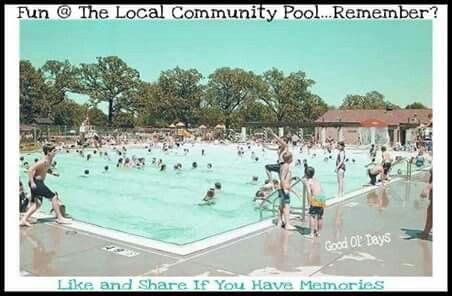 an outdoor swimming pool with people playing in the water and onlookers watching