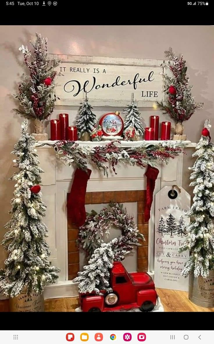 a mantel decorated with christmas trees and candles