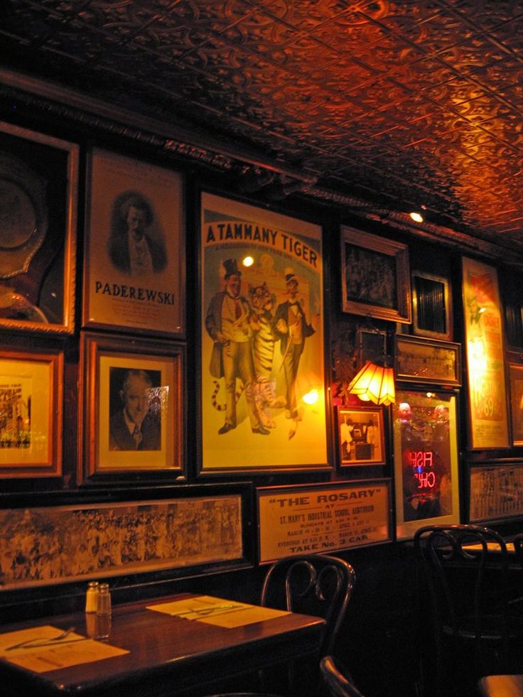 an old fashioned restaurant with posters on the wall