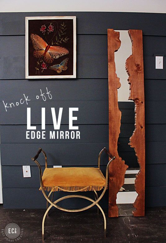 a chair and mirror in front of a wall with live edge mirror written on it