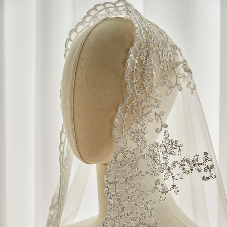 a mannequin wearing a veil and head piece