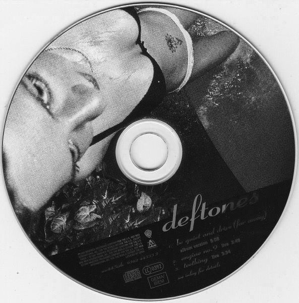 a black and white photo of a woman with her head down on a cd disc