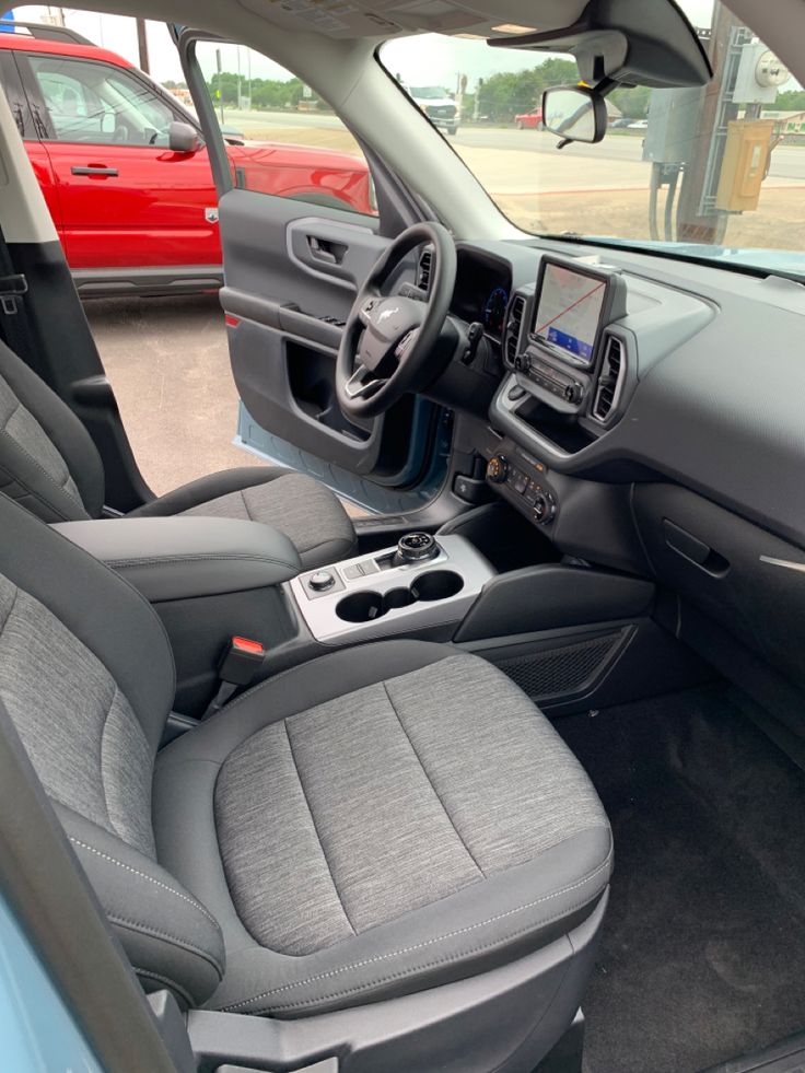 the interior of a car with grey leather seats