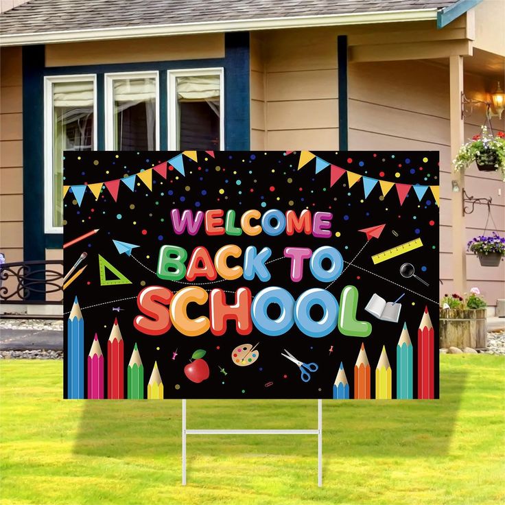 a welcome back to school yard sign in front of a house with lawn and grass