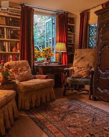 a living room filled with furniture and a large window covered in sunflowers next to a book shelf