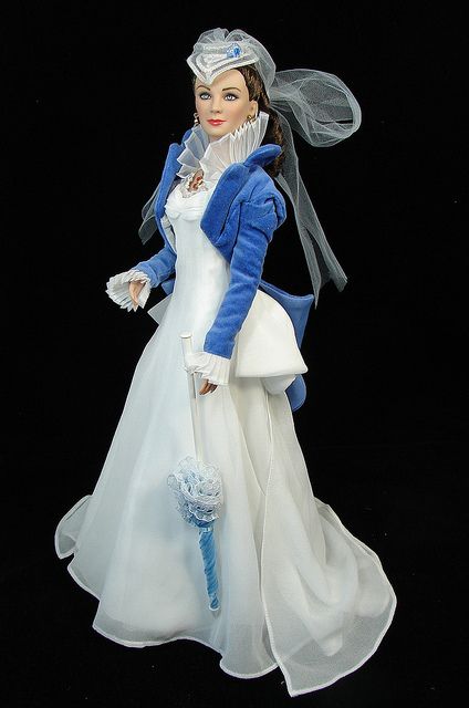 a figurine is dressed in white and blue