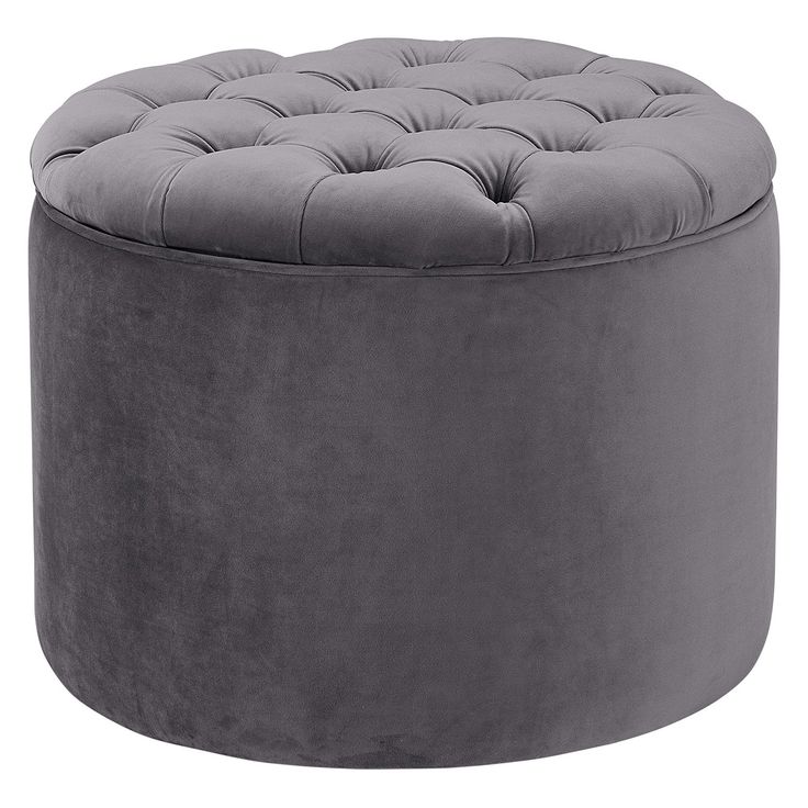 a grey round ottoman with buttons on the top and bottom, sitting in front of a white background