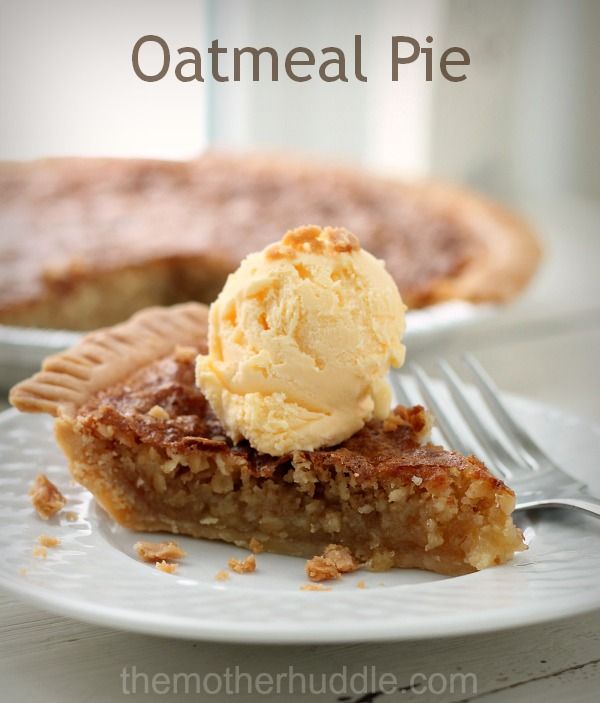 a piece of pie with ice cream on top is sitting on a plate next to a fork