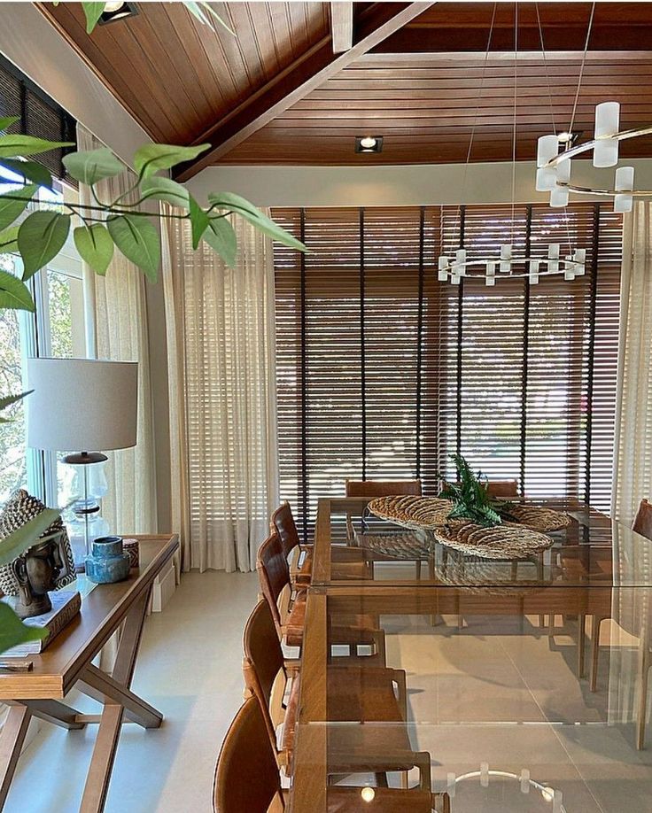 a dining room with wooden furniture and windows