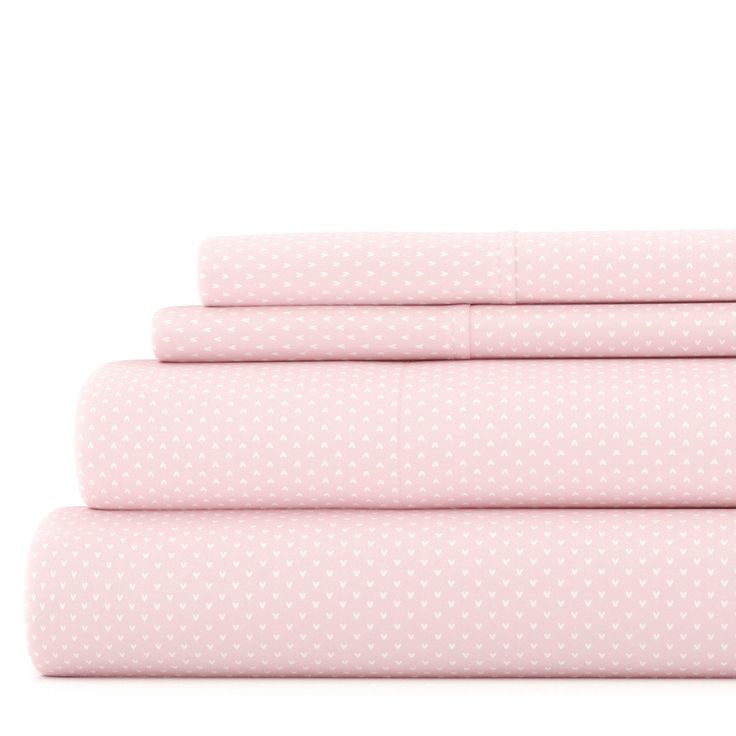 pink sheets with white polka dot print on the sheets and pillowcases are folded together