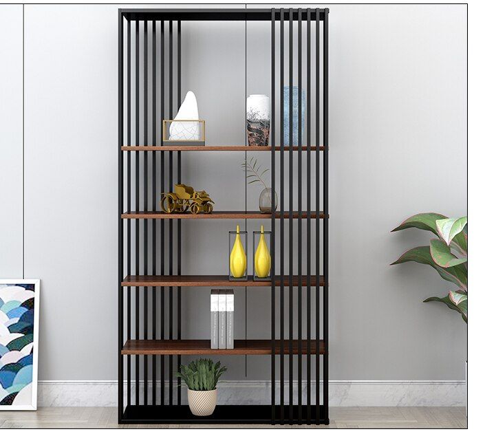 a book shelf with vases and bottles on it next to a potted plant