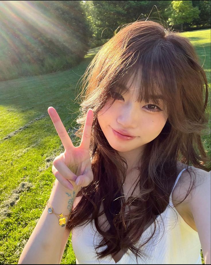 a young woman making the peace sign with her fingers