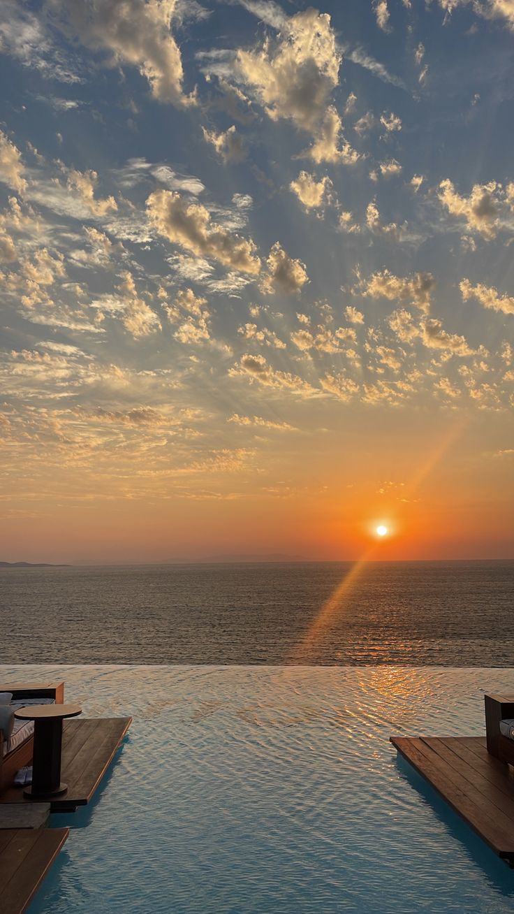 the sun is setting over an empty swimming pool