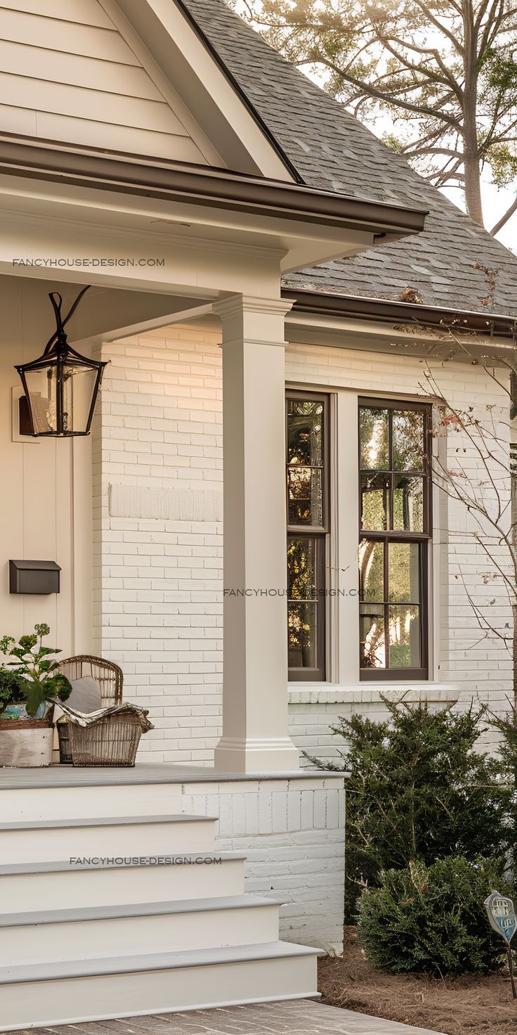 the front porch of a white brick house