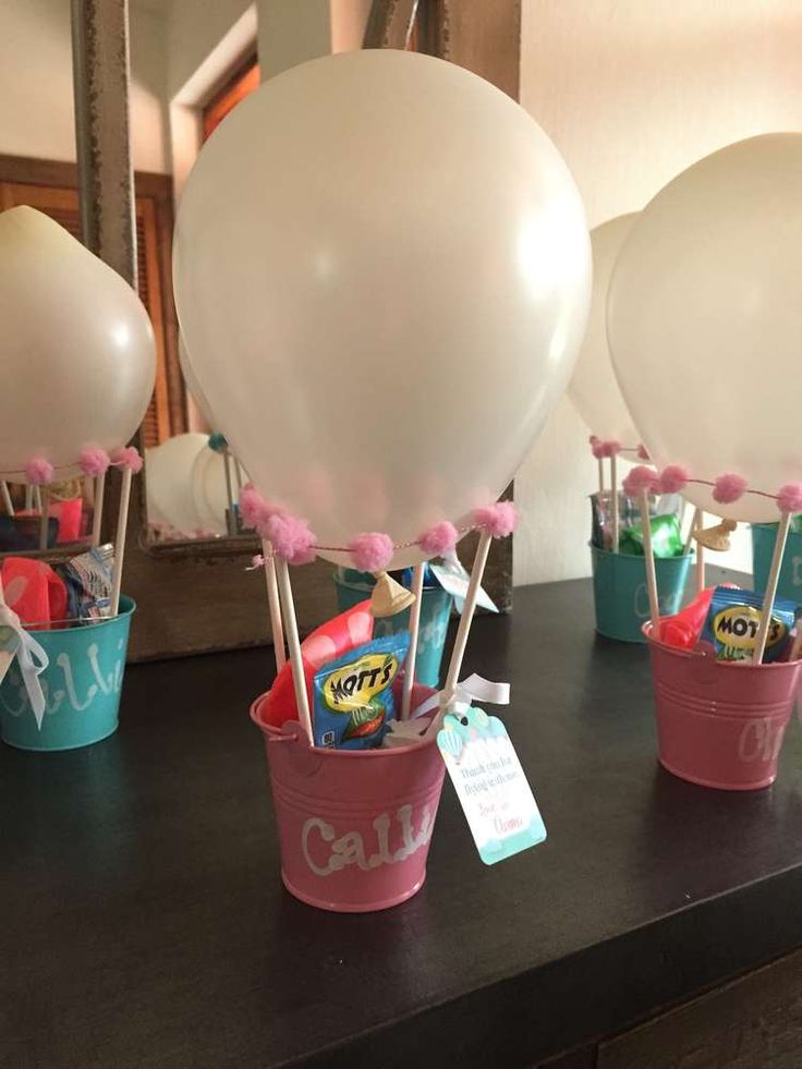 balloons and candy in buckets on a table