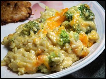 a white plate topped with macaroni and cheese covered in broccoli