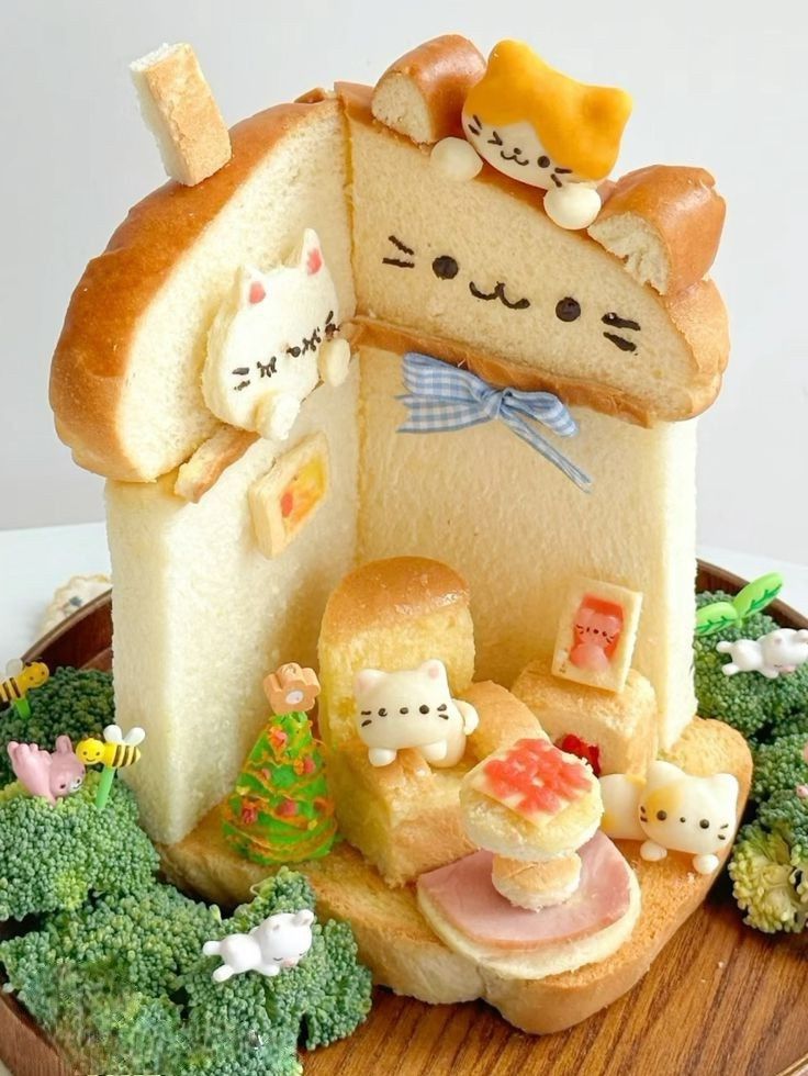 there is a cake shaped like a house with cats on it