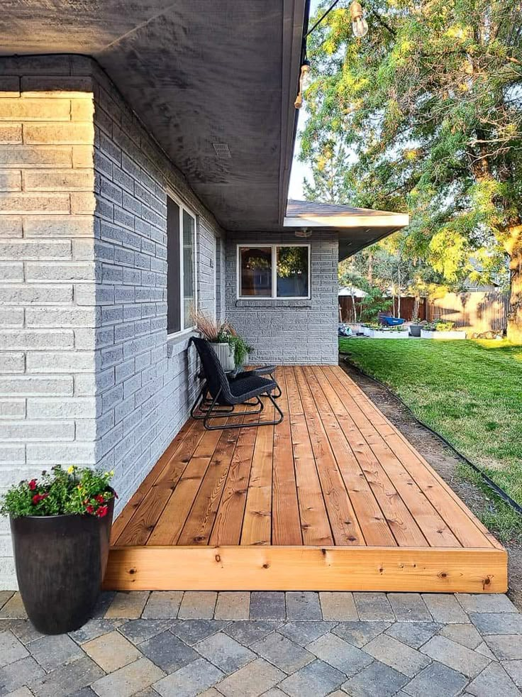 a wooden deck in front of a house