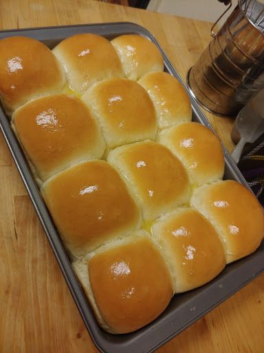 a pan filled with bread sitting on top of a wooden table