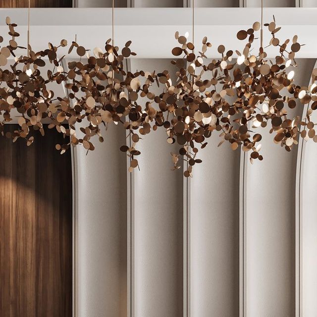 a chandelier hanging from the ceiling in front of a window with curtains behind it