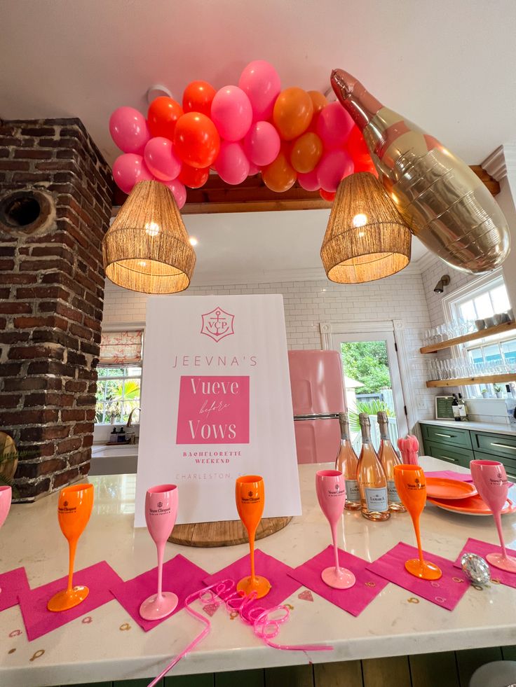 Vueve before vows bachelorette party decor, champagne party, champagne glasses, orange and pink balloons, ring finger foam finger, Bach babes, balloons, pop the bubbly SHES getting a hubby, balloon arch in background of table set up for a bachelorette party in Charleston Bachelorette Party Themes Champagne, Pop The Bubbly Shes Getting A Hubby Bachelorette, Veuve Before Vows Bachelorette Decor, Lilly Pulitzer Bachelorette Party, Pink And Yellow Bachelorette Party, Pink And Orange Bachelorette Party Theme, Vueve Bachelorette Theme, Pink And Orange Bachelorette Theme, Vueve Before Vows Bachelorette