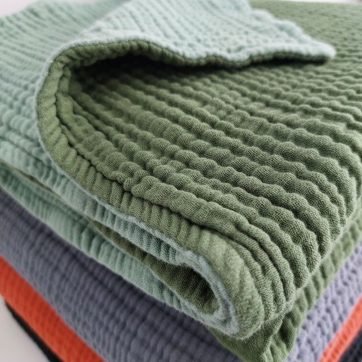 four blankets folded on top of each other