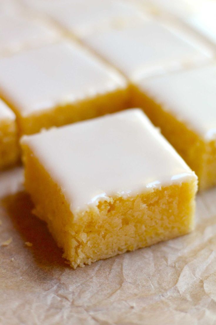 three pieces of cake sitting on top of a piece of parchment paper with icing