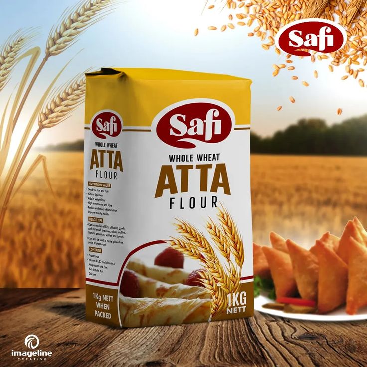 an advertisement for saff's whole wheat atta flour on a wooden table