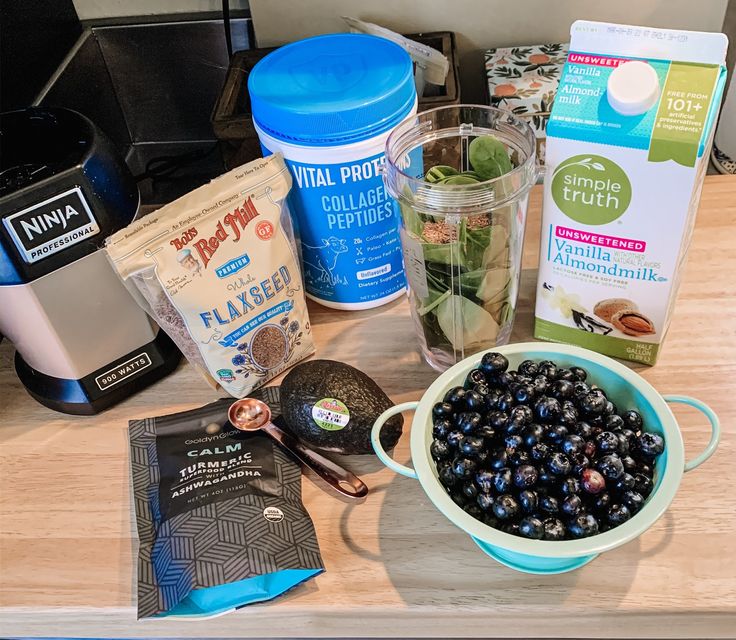 the ingredients to make blueberry muffins sit on a counter