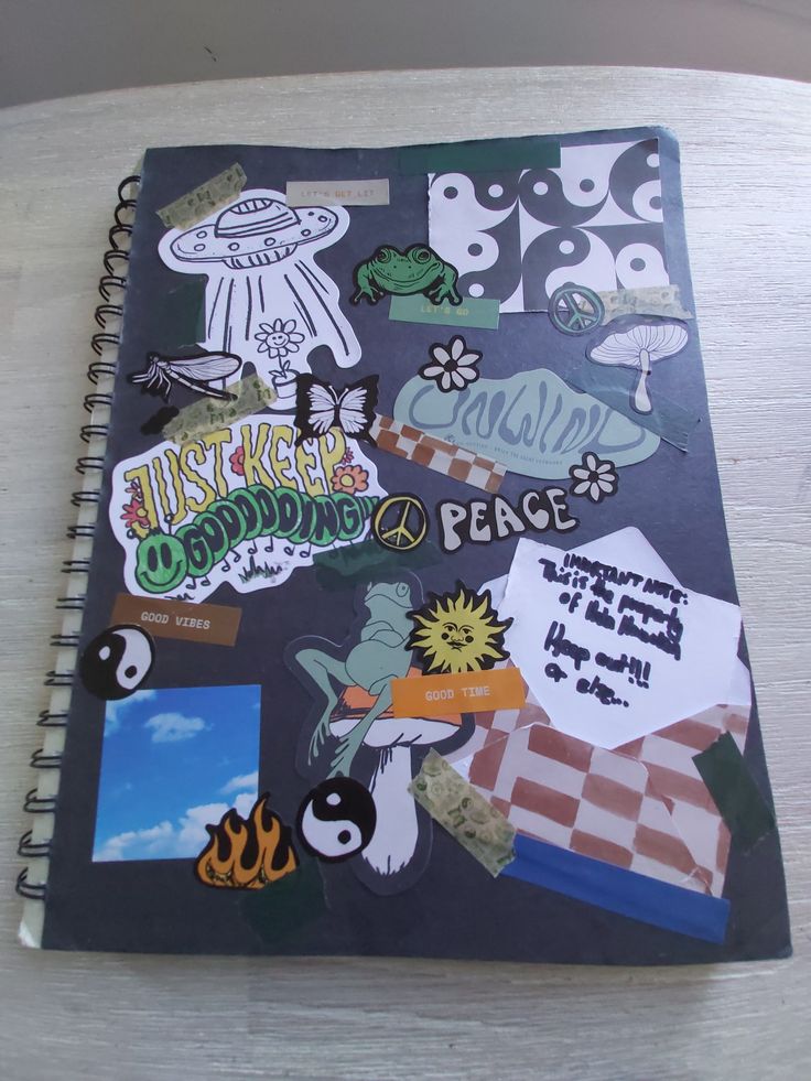 a notebook with stickers on it sitting on a table