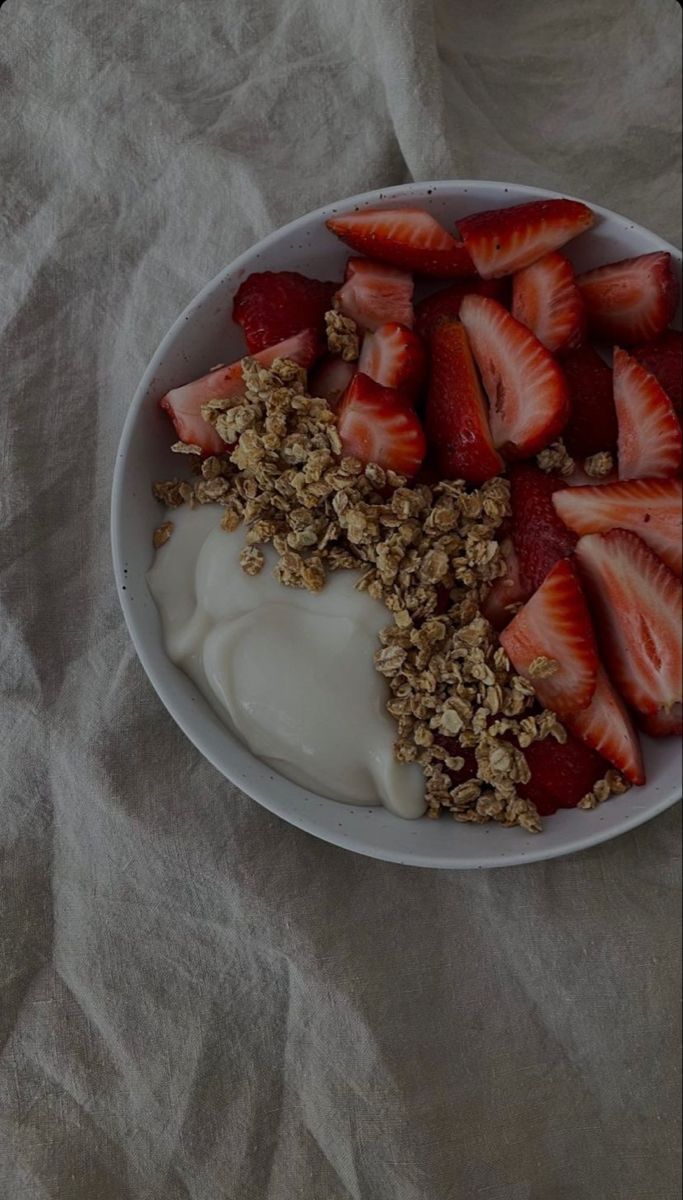 strawberries and yogurt are arranged in a bowl