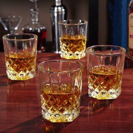 three glasses filled with whiskey sitting on top of a table