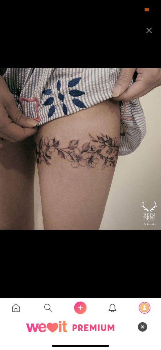 a woman is showing off her thigh with tattoos on the side and flowers growing out of it