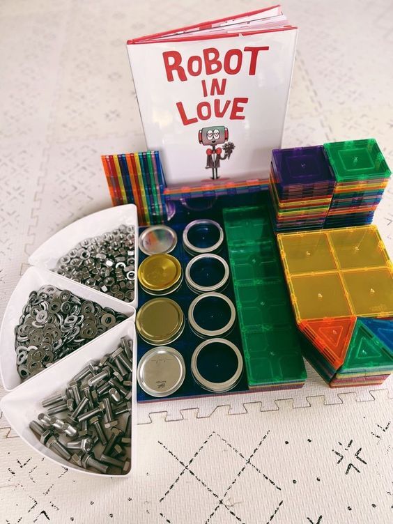 an assortment of crafting supplies on a table with a robot in love sign above it