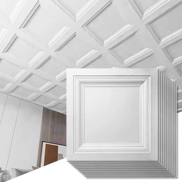 an empty room with white walls and ceiling tiles on the ceiling is shown in this image