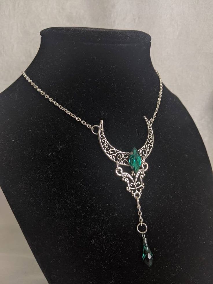 A beautiful and unique jewelry set which includes a pendant necklace and hand chain, featuring a filigree moon and connector charm with a crystal decorating the center of the moon and a drop crystal hanging from the pendant. Choose Crystal Shape between horse eye (as pictured) or teardrop (horse eye will be sent if unspecified) Choose necklace length from the diagram in the listing picture (14 inches plus 1.5 inch extension chain will be sent if unspecified) Fantasy Moon Shaped Jewelry Gift, Gothic Festival Jewelry With Moon Charm, Fantasy Silver Jewelry With Moon Charm, Fantasy Metal Pendant Jewelry, Elegant Moon Phase Jewelry For Festivals, Fantasy Pendant Jewelry For Festival, Elegant Moon Phase Festival Jewelry, Fantasy Style Pendant Jewelry For Festival, Gothic Teardrop Silver Jewelry