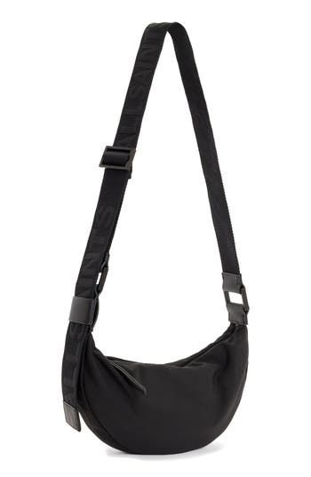 A half-moon silhouette lends visual intrigue to a spacious crossbody bag fashioned with a constrasting, adjustable strap. Cotton lining Textile with leather trim Imported Allsaints Crossbody Travel Shoulder Bag, Allsaints Crossbody Shoulder Bag For Travel, Allsaints Black Travel Bag, Allsaints Black Bags For Everyday Use, Black Allsaints Bag With Adjustable Strap, Allsaints Black Everyday Bags, Allsaints Crossbody Travel Bag, Modern Allsaints Crossbody Shoulder Bag, Allsaints Black Shoulder Bag For Everyday