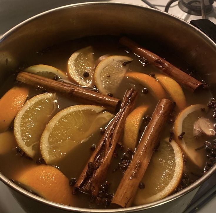 a pot filled with lemons and cinnamon sticks