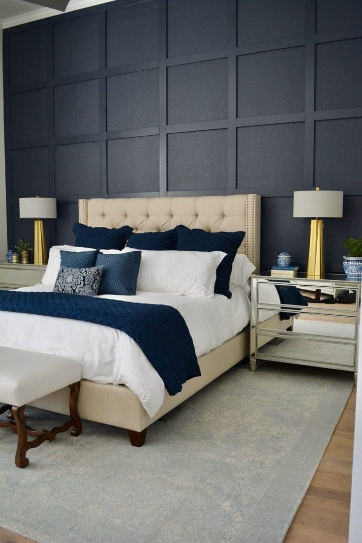 a large bed with blue and white pillows in a bedroom