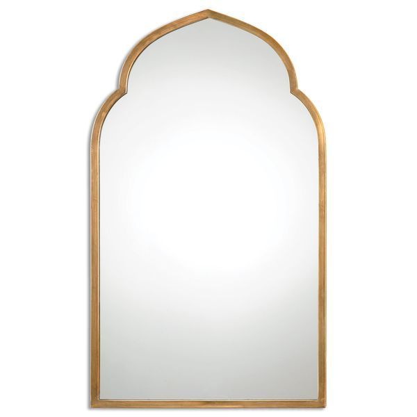 an arched mirror on a white wall