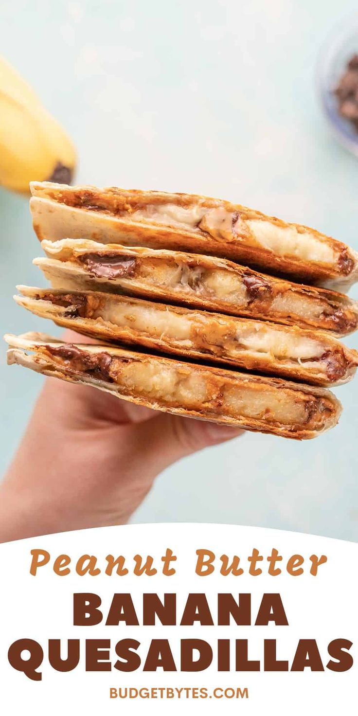 a person holding a stack of banana quesadillas in front of some bananas