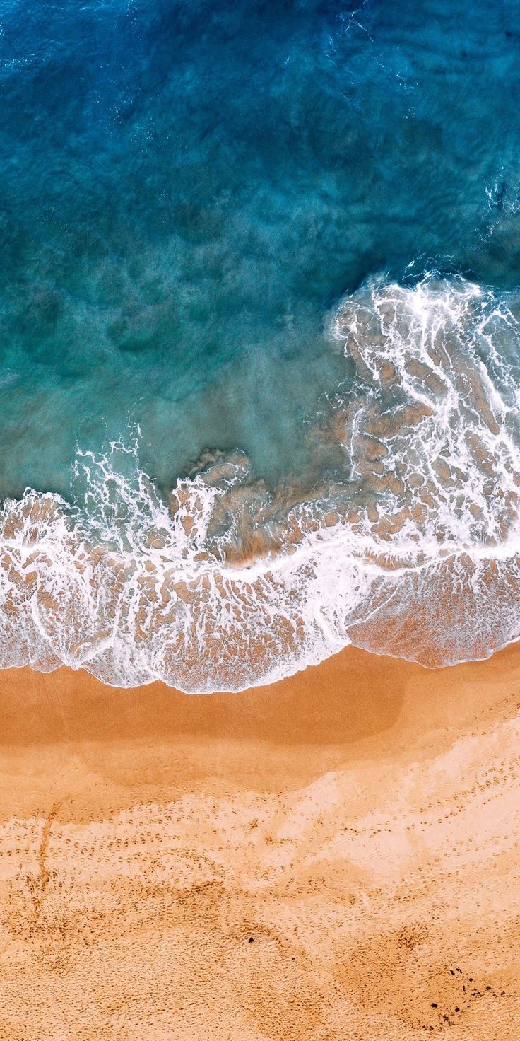 an aerial view of the ocean and beach