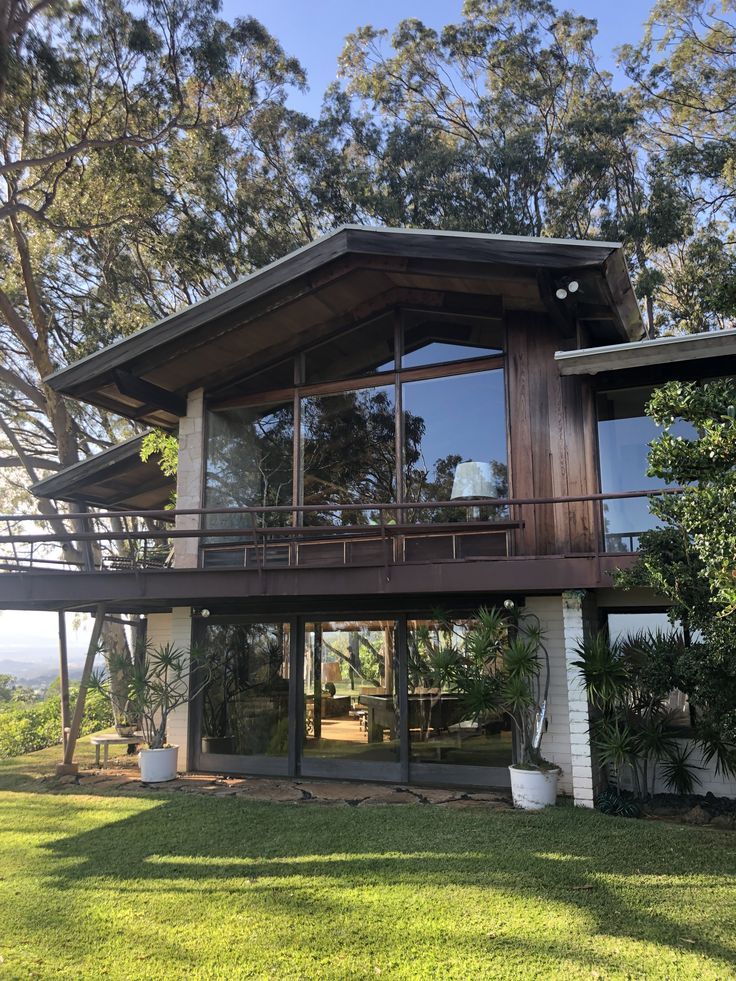 a large house with lots of windows and grass